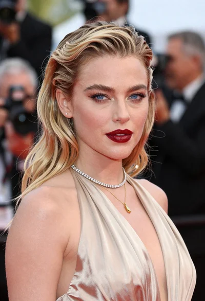Close up portrait of blonde woman in champagne gown at gala