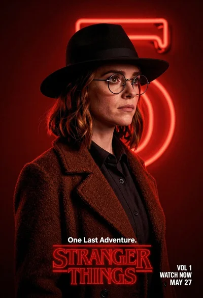 Woman in black fedora and wool coat against red neon background