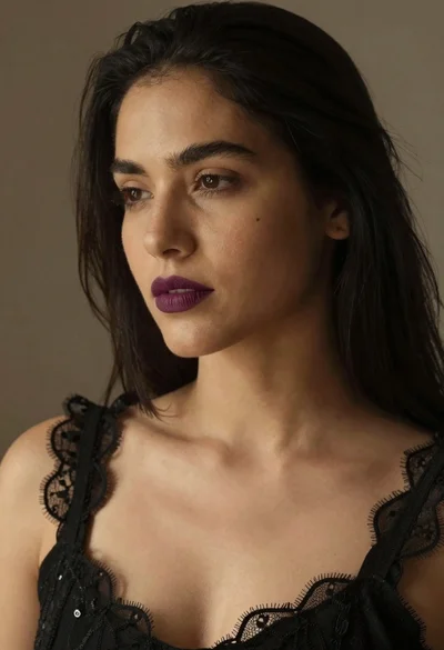 Close up portrait of woman with dark hair wearing black lace top