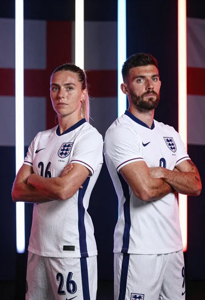 Two football players in white england kits standing back to back with