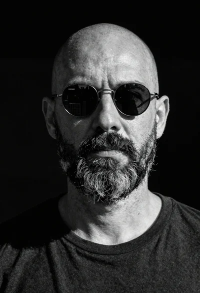 Black and white portrait of bald man with full beard