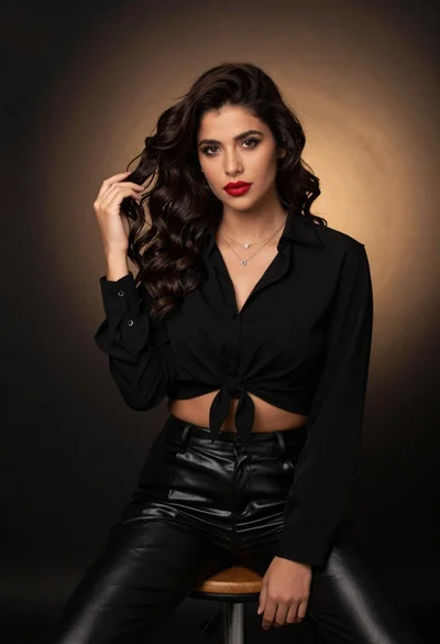 Studio portrait of woman with dark hair on gradient background