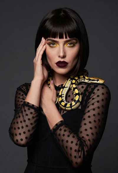 High fashion portrait of woman with black bob and snake