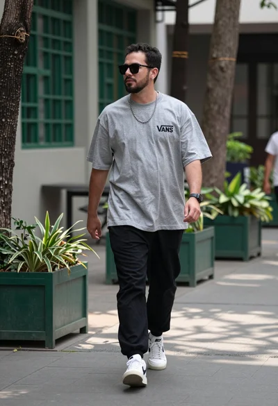 Man walking down paved path in urban courtyard setting with greenery
