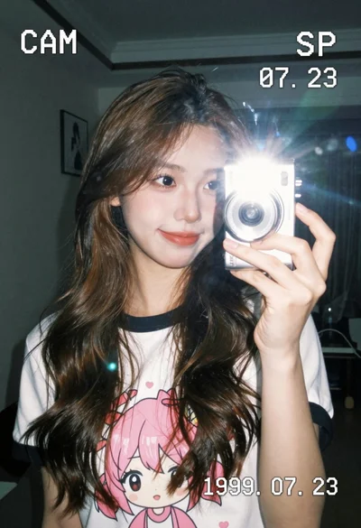Close up mirror selfie of young woman with brown hair in white
