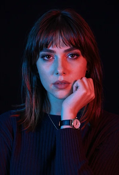Closeup portrait of woman with fair skin and brown hair in dark
