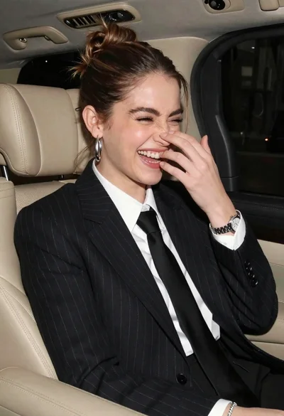 Candid medium close up of young woman laughing in luxury car seat