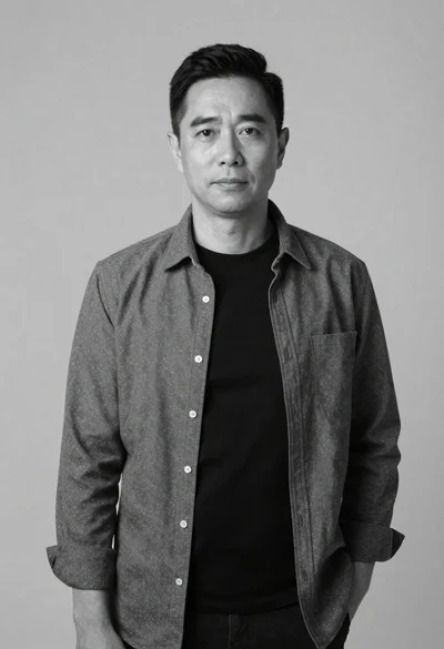 Black and white portrait of man against plain background