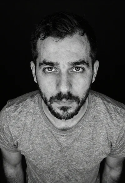 Black and white portrait of man looking up at camera