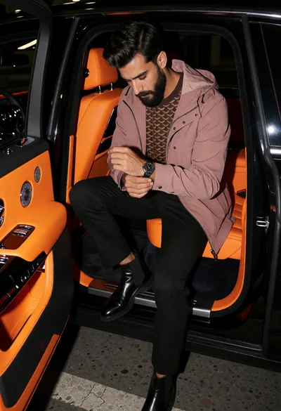 Stylish man exiting luxury car with vibrant orange interior accents
