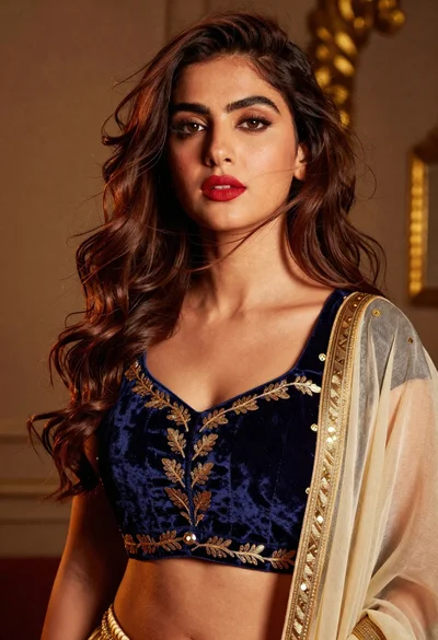 High fashion portrait of woman in navy velvet crop top studio setting
