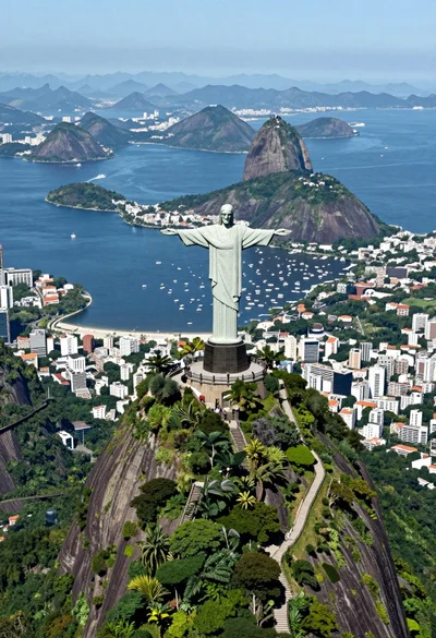 Aerial view of christ redeemer statue overlooking coastal city bay and mountains