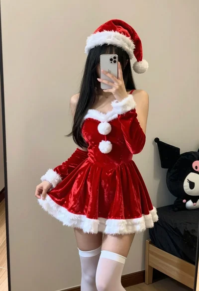 Young woman in santa costume taking mirror selfie in beige bedroom