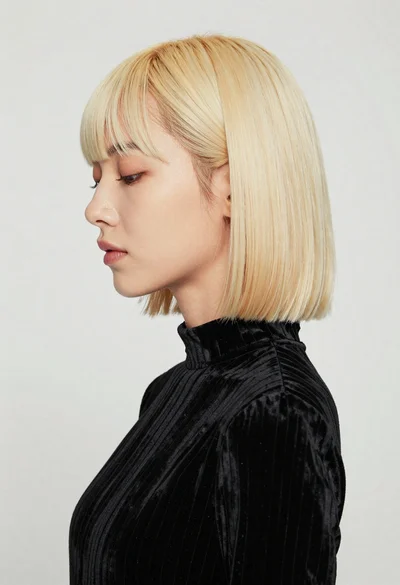 Studio portrait of woman with platinum blonde bob hairstyle