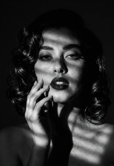 A Dramatic black and white portrait of woman with dark wavy hair