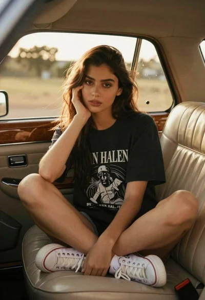 Young woman in vintage car with golden hour backlighting