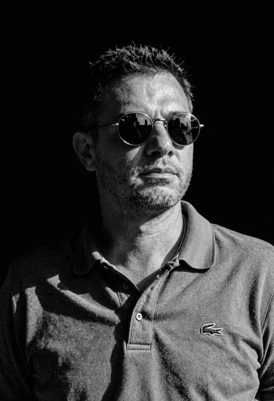 Black and white portrait of man in polo shirt