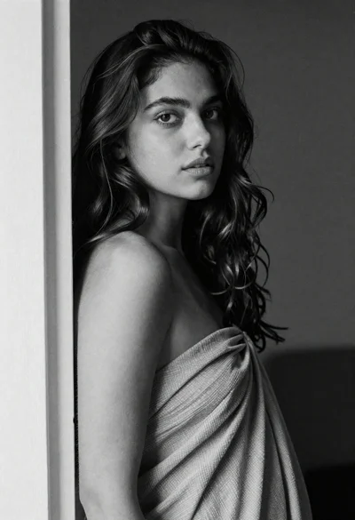 Black and white portrait of woman by doorframe