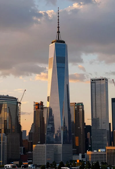 Wide angle view of massive modern skyscraper cityscape at sunset
