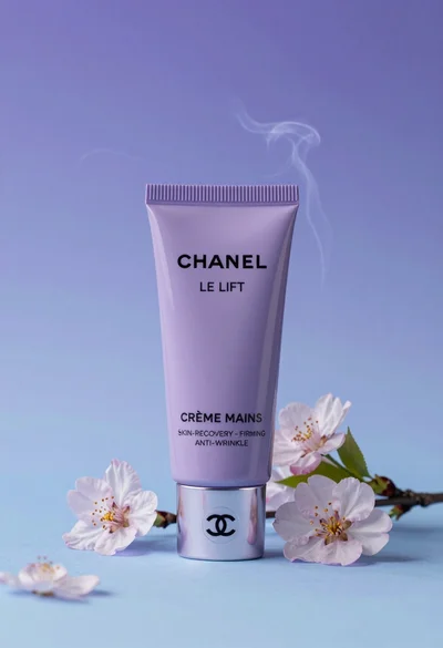 Sleek lavender hand cream tube displayed with cherry blossoms in studio