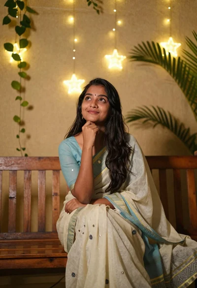 Young woman in traditional indian outfit sitting on wooden bench indoors
