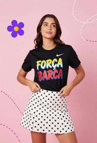 Young woman in graphic tshirt and polka dot skirt against pink background