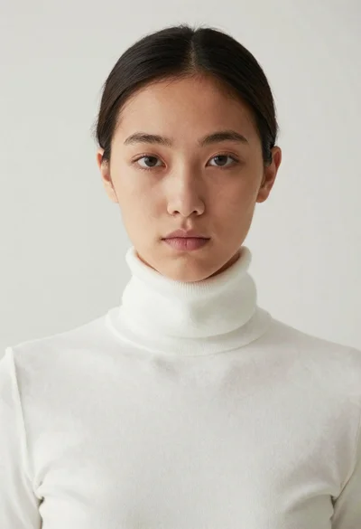 Close up portrait of woman in white turtleneck sweater