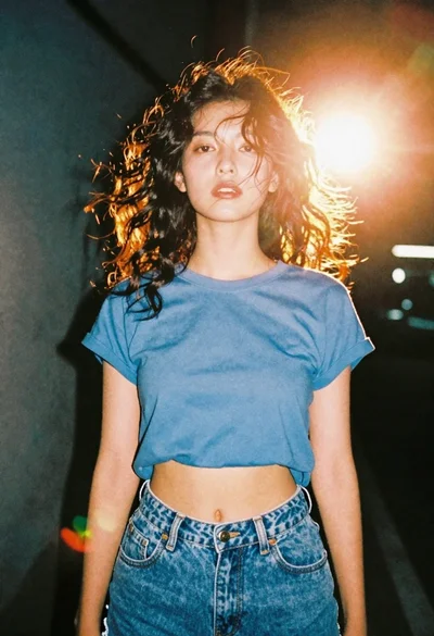 Portrait of young woman in blue crop top and denim shorts