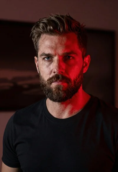 Closeup portrait of rugged man with short brown hair and full beard