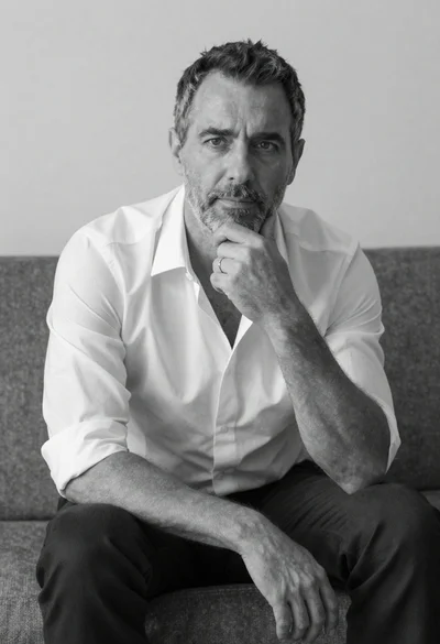 Black and white portrait of a man sitting on a couch