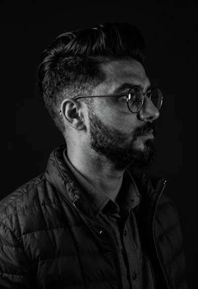 Black and white studio portrait of man with beard