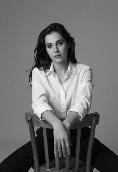 Black and white portrait of woman on wooden chair