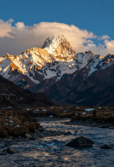 Majestic snow capped mountain range viewed from a river at golden hour