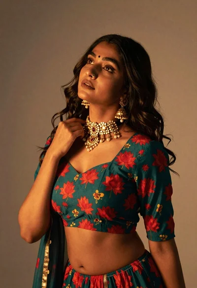 Young woman in traditional indian outfit touching ornate necklace on soft background
