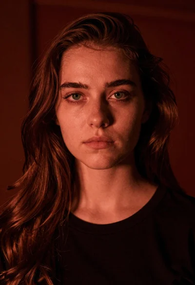 Closeup portrait of young woman with brown hair and green eyes in