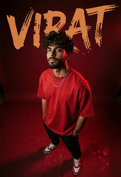 Young man in red tshirt standing before bold brush stroke lettering