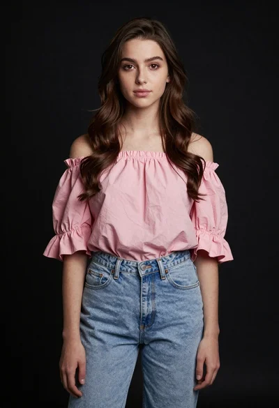 Young woman in pink top and blue jeans on black background
