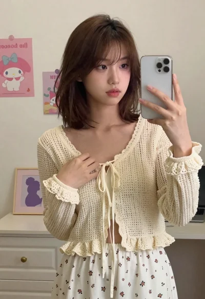 Fair skinned young woman with brown hair taking a mirror selfie in