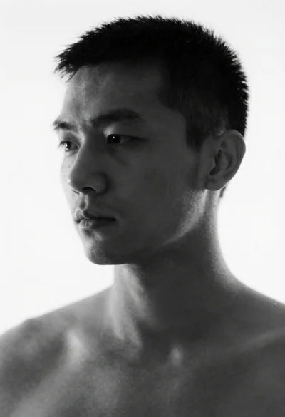 Monochrome portrait of a man against a stark white background