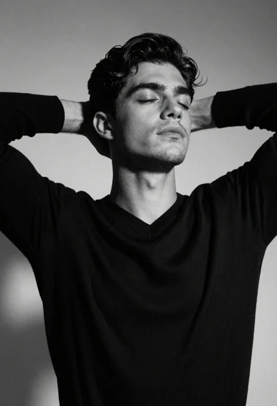 Black and white portrait of young man with raised arms