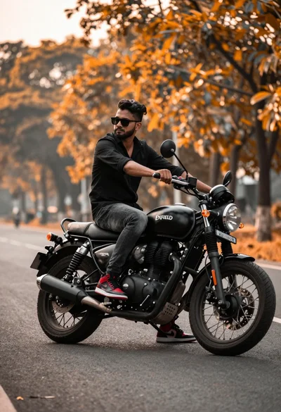 Man on black motorcycle on paved road with orange foliage background
