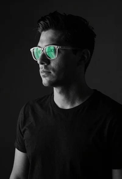 Black and white portrait of stylish man with green glasses