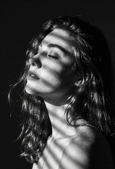 Black and white portrait of serene woman with closed eyes