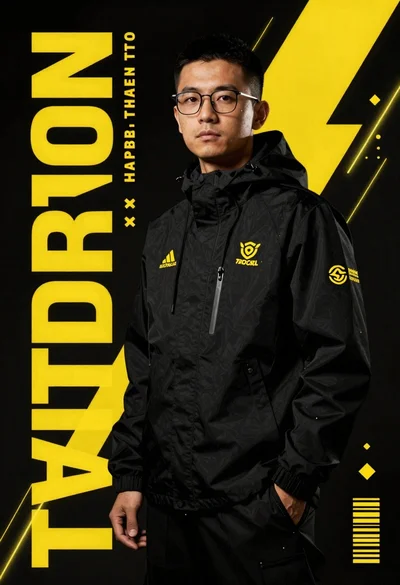 Man in black hooded jacket with yellow branding logos standing against dark