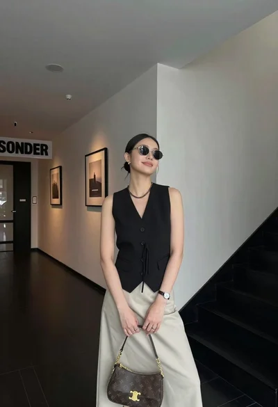 Stylish young woman posing in modern interior hallway lobby setting