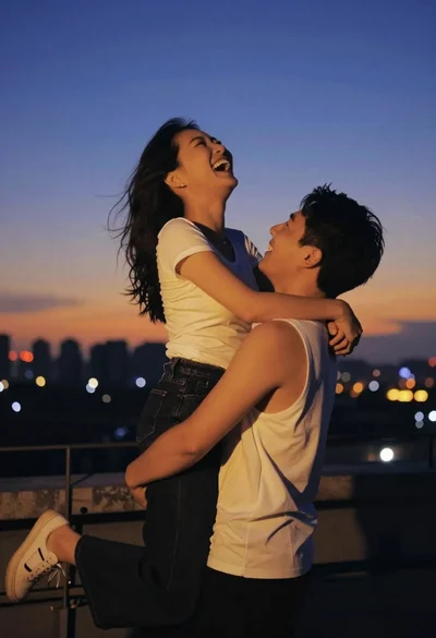 Joyful couple embracing on rooftop overlooking twilight city skyline