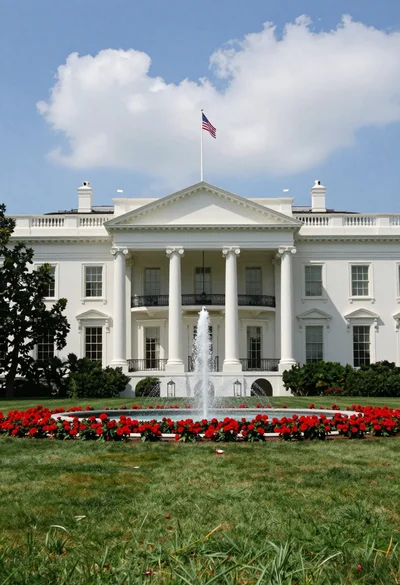 Majestic white neoclassical building with a grand portico stands under blue sky