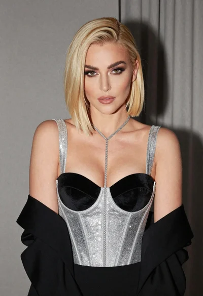 Glamorous portrait of woman with platinum blonde hair in silver corset top