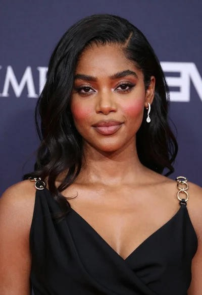 Close up portrait of dark skinned woman with black hair and jewelry