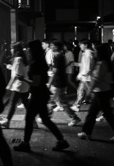 Monochromatic long exposure of blurred crowd in urban space